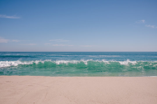 Waves breaking on a sandy beach in summer, Australia