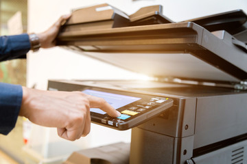 Close-up bussiness man Hand press button on panel of printer, printer scanner laser office copy...