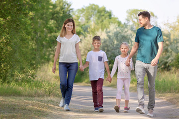 Family walking in park on summer day