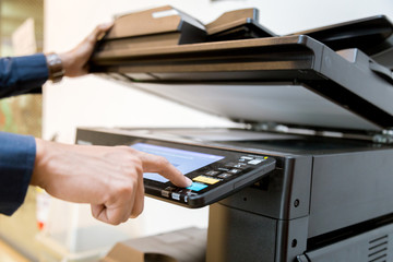 Close-up bussiness man Hand press button on panel of printer, printer scanner laser office copy...