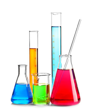 Laboratory glassware with colorful liquids on white background