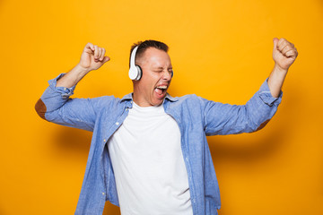 Fototapeta premium Emotional man listening music with headphones.