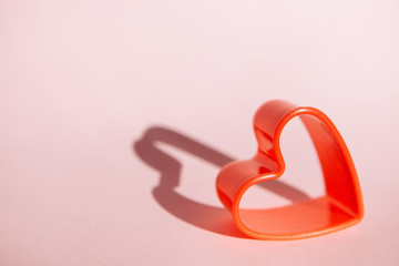 Love concept with red heart shape on pink background, valentines day