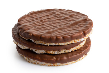 Stack of three chocolate rice cakes isolated on white.