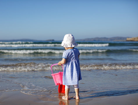 baby girl playing at summer beach