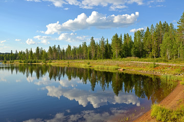 Fototapeta na wymiar Picturesque evening on northern lake. Summer landscape. Finnish Lapland