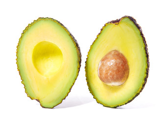 Ripe cut fresh avocado on white background