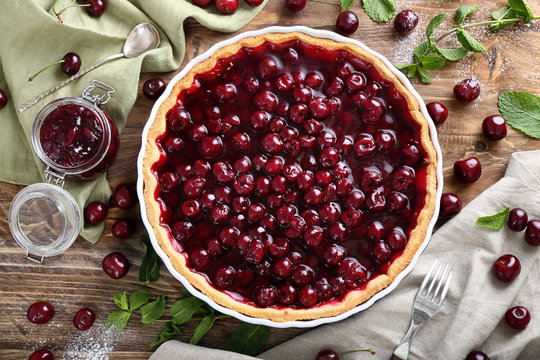 Tasty cherry pie on wooden table