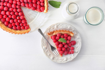 Tasty homemade raspberry pie with fresh milk on table