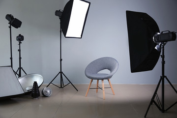 Modern chair in photo studio with professional equipment