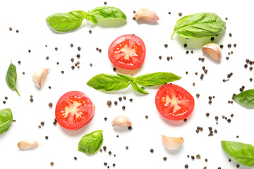 Fresh sliced tomatoes with basil and spices on white background