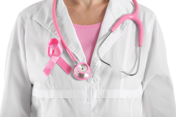 Female doctor with pink ribbon and  stethoscope, closeup. Breast cancer concept