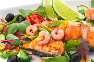 Tasty fish and fresh salad on plate, closeup