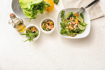 Composition with tasty salad in bowls on table