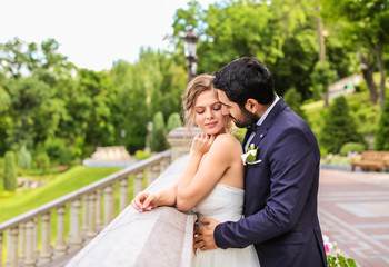 Naklejka premium Happy young bride with her groom outdoors