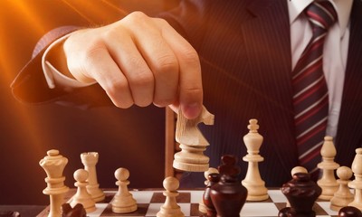 Businessman Hand Holding a Chess Piece © BillionPhotos.com