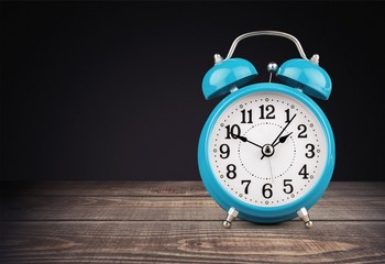 Retro alarm clock on table  background