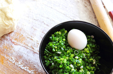 Products or ingredients for cooking patties. The filling consists of onions and eggs. Pirozhok - a dish of Russian and European cuisine from the dough with stuffing. Selective focus, copy space.