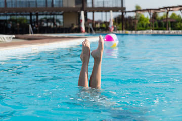 Beautiful female legs stick out of water