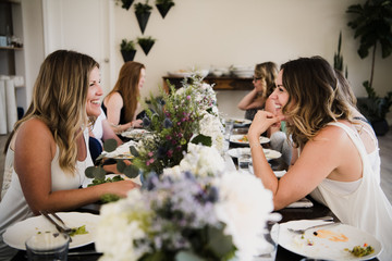 Women enjoying friendship and meal in yoga retreat