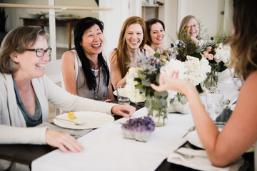 Women enjoying friendship and meal in yoga retreat