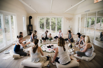 Women around circle in yoga retreat
