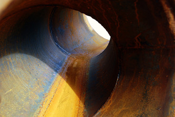 bulb / large rusty pipe with a small hole at the end 