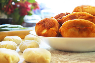 Process of preparation of patties. The filling consists of onions and eggs. Pirozhok - a dish of Russian and European cuisine from the dough with stuffing. Selective focus, copy space.