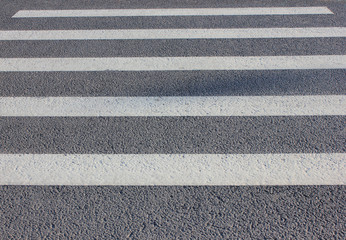 Pedestrian Crosswalk with Parallel Painted White Zebra Lines on Gray Asphalt Road Background. Close Up View of Empty Pedestrian Crossing Point at Downtown City Street with No People.