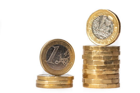 Stack Of Euro Coins And New Pound Coins Isolated On White Background