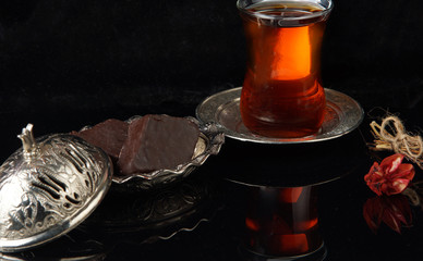 Baklava on a plate next to a cup of coffee