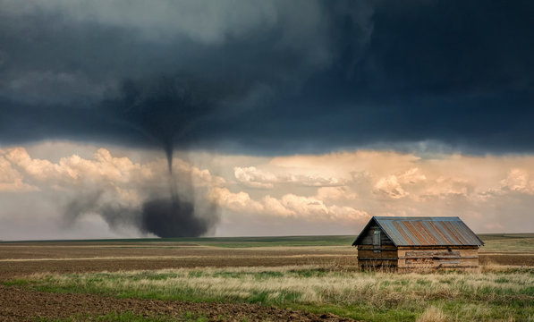 Landspout-tornado hybrid on plains, barn in foreground, Cope, Eastern Colorado, US