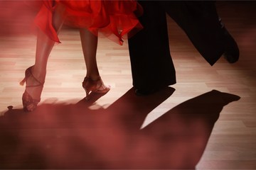 Man and woman dancing Salsa on dark