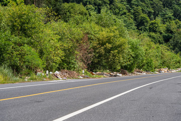 Phuket, THAILAND - July 26, 2018: The pile of garbage on the side of road in Phuket, problem of garbage pollution and environmental. Illegal Garbage Issues.