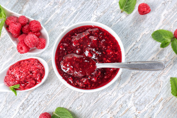 Composition with tasty raspberry jam on wooden table