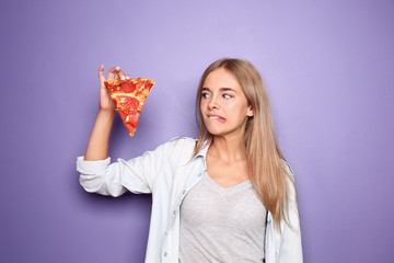 Emotional woman with slice of delicious pizza on color background