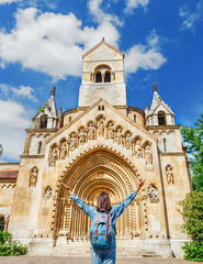 Mixed race woman traveler with backpack admiring tourist sights and destinations in Europe. Jaki...