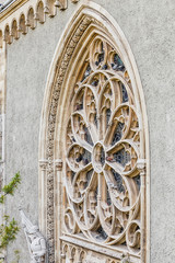 Pigeons resting on the gothic window of a historic church or cathedral