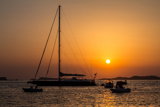 Sunset over sea with boats