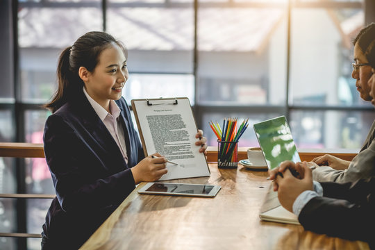Businesswoman with documents describing the terms of the contract and do business together. Business contract details