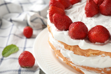 Delicious cake with strawberries on table, closeup