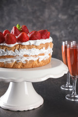 Dessert stand with delicious strawberry cake on table
