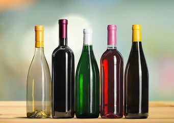 Wine bottles in row on desk