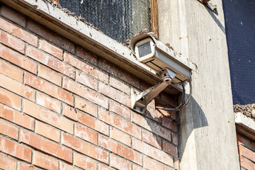 Old dirty Security camera on industrial building