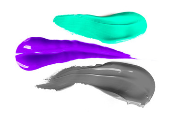 Real liquid color paint stamps. Textured surface isolated on white background. Shiny light glossy reflections. Minimalistic flat lay picture. Blue, purple and grey shades