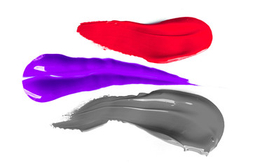 Real liquid color paint stamps. Textured surface isolated on white background. Shiny light glossy reflections. Minimalistic flat lay picture. Red, purple and grey shades