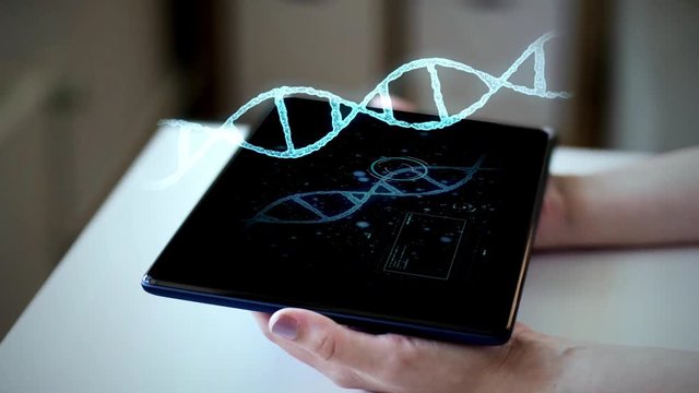 technology, science and genetics concept - hands with tablet pc computer and 3d hologram of virtual dna molecule at home