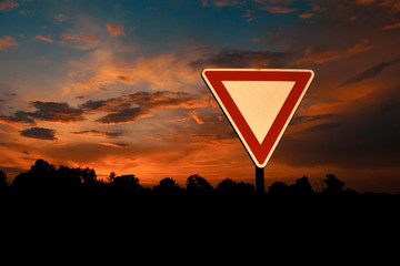 Yield Sign with Sunset Sky on Background