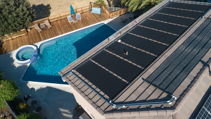 Thermal Solar Panels Installed on the Roof of a Large House - Powered by Adobe