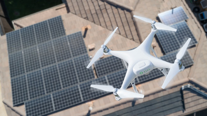 UAV Drone Inspecting Solar Panels On Large House